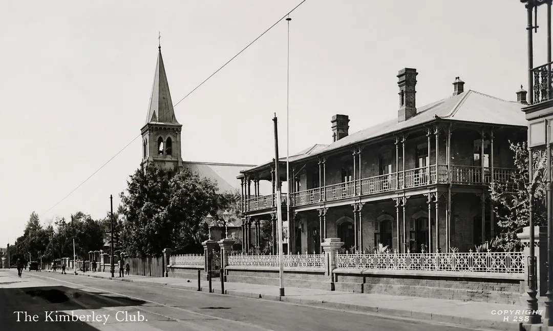 The Kimberley Club and St Mary’s Catholic Church on Du Toitspan Road, showing the later stone bell tower and the expanded Club frontage.