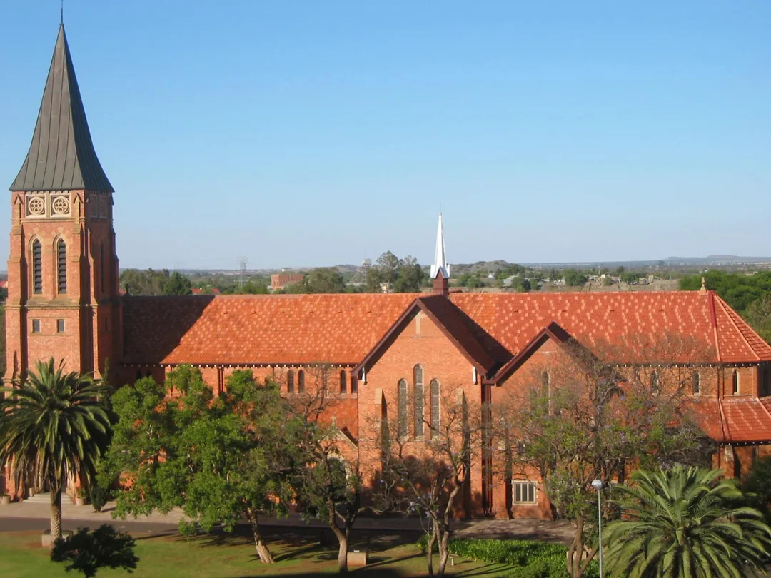 St Cyprian's Cathedral on Du Toitspan Road in Kimberley, showing its Gothic Revival architecture, stone tower and long nave.