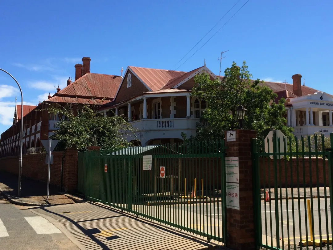 Undamaged Oppenheimer House, formerly Nazareth House, showing its brick walls, arches and long collonaded structure.
