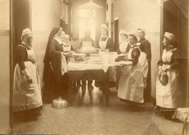 Historic photograph showing nurses and nursing sisters working inside Kimberley Hospital.