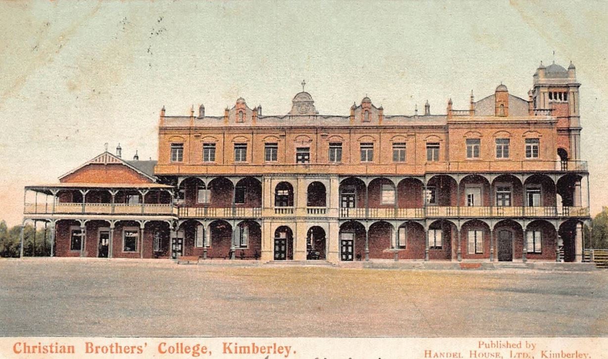 Early twentieth-century postcard showing Christian Brothers’ College Kimberley with the original brick College frontage, arcaded verandas, tower and smaller adjoining building on the left before later extensions.