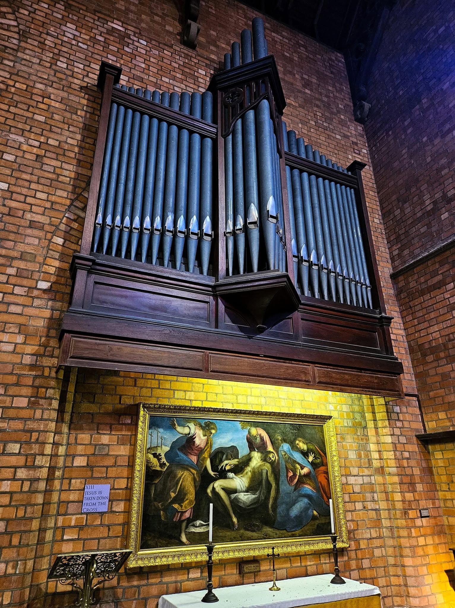 The historic J. W. Walker & Sons pipe organ inside St Cyprian's Cathedral in Kimberley, mounted above a religious painting and altar.