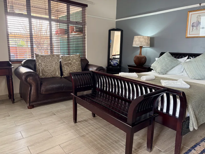 Room 5 queen-size bed and sofa at the Solomon Edwardian Guest House