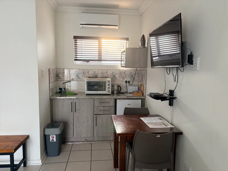 Room 7 kitchenette with table and chairs at the Solomon Edwardian Guest House