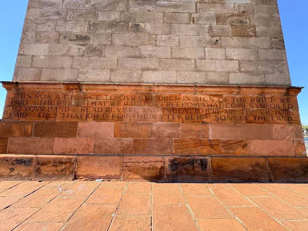 Close-up of Rudyard Kipling's dedication carved into the sandstone base of the Honoured Dead Memorial in Kimberley.