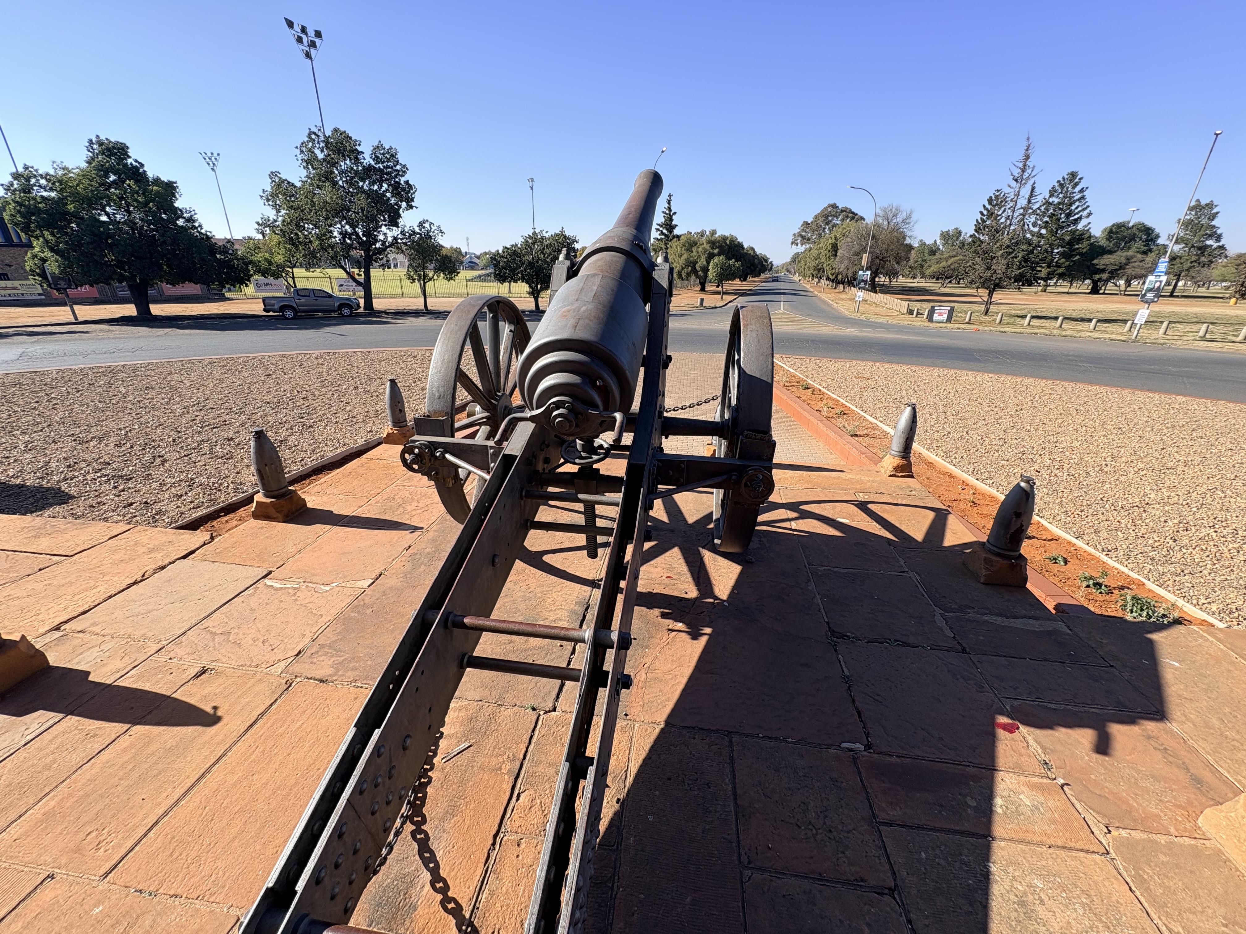 View looking along the barrel of Long Cecil towards the south-west along Dalham Road, showing the gun's deliberate alignment towards the former Orange Free State from where Boer forces besieged Kimberley during the Siege of Kimberley.