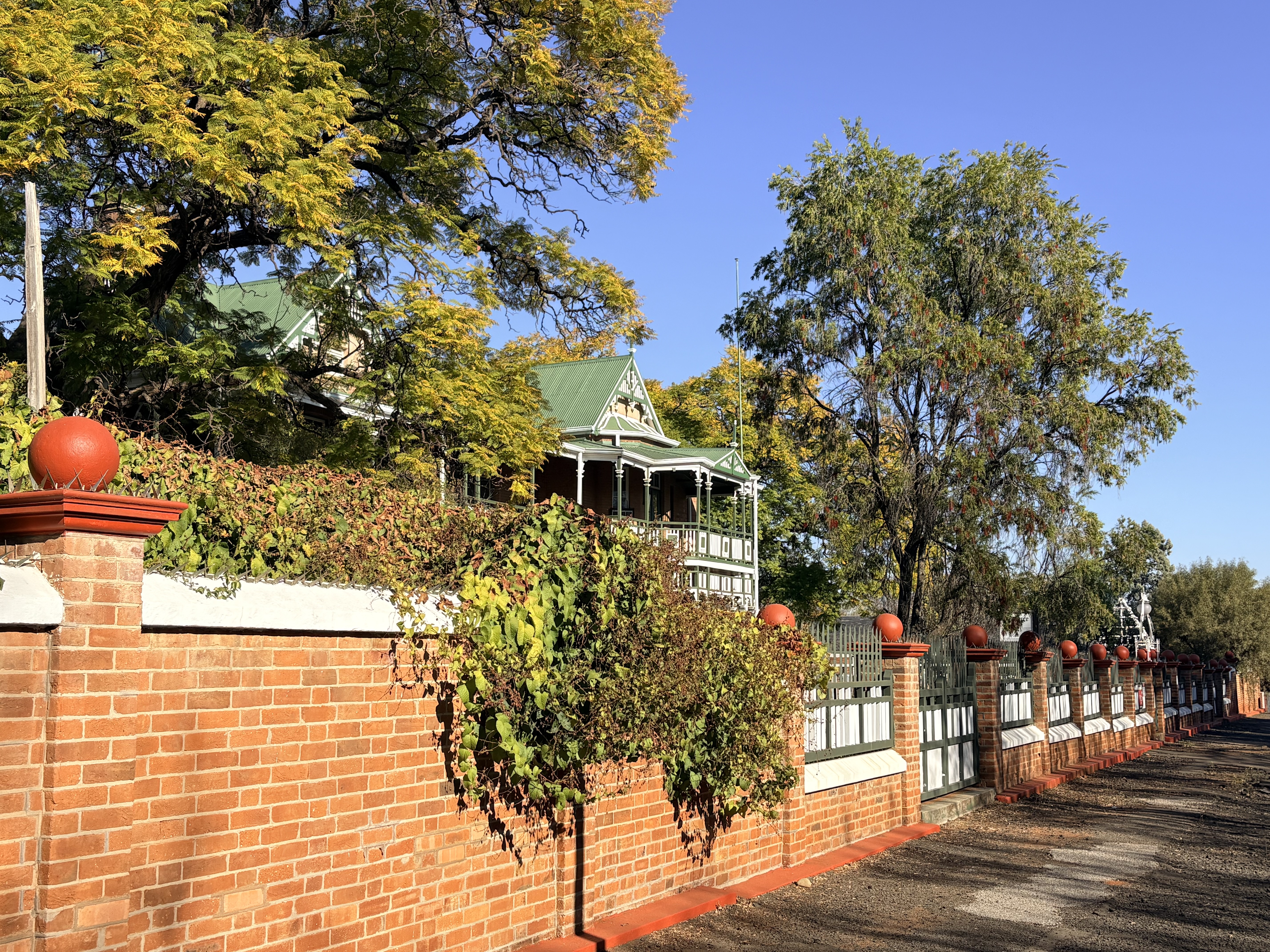 Historic residence at 10 Lodge Road viewed along its brick boundary wall in Kimberley.