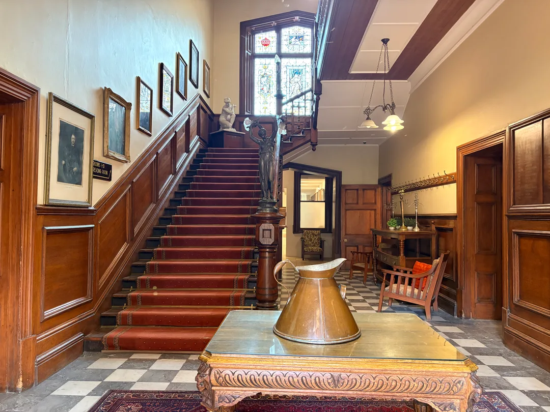 The magnificent double bend in the timber staircase, viewed from the ground floor.