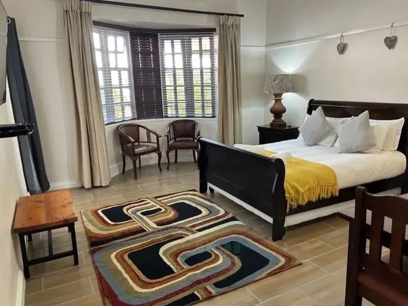 Room 4 queen-size bed and bay window at the Solomon Edwardian Guest House